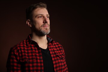 Obraz premium Man with beard on dark background. Space for text