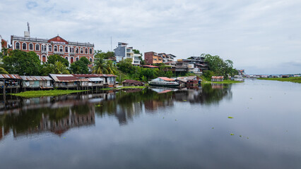 Panoramic aerial drone view of the riverfront boulevard of Iquitos along the R&iacute;o Amazonas in the Peruvian Amazon, tropical city surrounded by rainforest and rivers, gateway for travel and tourism