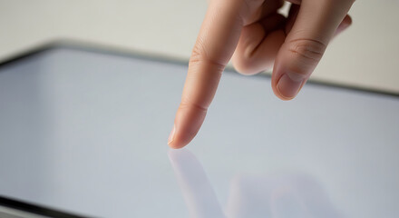 Naklejka premium a human finger tapping or touching a reflective digital tablet screen illustrating modern technology interaction and user experience