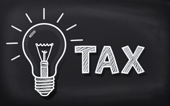 Chalkboard shows light bulb and "TAX" symbolizing ideas about