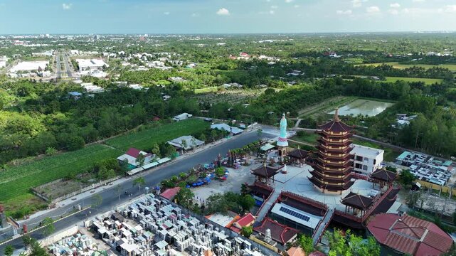 Jade Buddha Pagoda, Vinh Long, Vietnam &ndash; 4K aerial drone view of Buddhist temple complex with multi-tier pagoda tower and Guanyin statue in the Mekong Delta