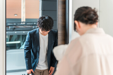 Fototapeta premium A businessman in a jacket and his female landlord greet each other at the entrance