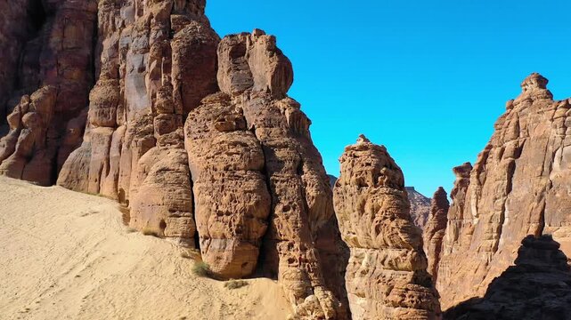 Drone Orbits Massive Sandstone Arch In AlUla Tilting To Reveal Ancient Tombs Carved Within Golden Hour-Lit Swirling Rock Layers, Dramatic Cinematic Desert Aerial &mdash; 11 March 2025.