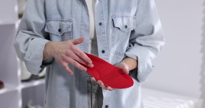 Woman holding one orthopedic insole indoors, closeup