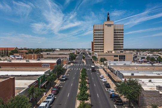 Aerial Drone View of Prosperity Bank Sign on Tall Commercial Office Building Surrounded By other Buildings With Blue Sky in Downtown Odessa, Texas