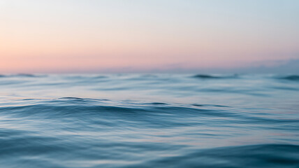 Fototapeta premium Calm ocean waves at twilight with soft pastel sky