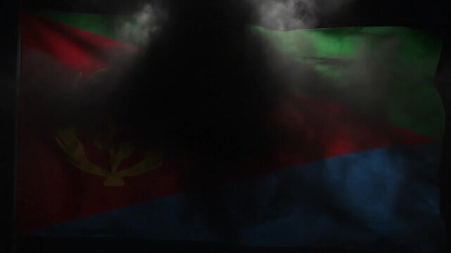 The national flag of Eritrea proudly waves with a spotlight illumination.