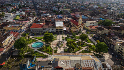 Fototapeta premium Panoramic aerial drone view of the main square of Iquitos with the historic Catedral de Iquitos in the heart of the Peruvian Amazon, vibrant tropical city known for culture history, travel and tourism