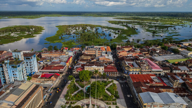 Panoramic aerial drone view of the riverfront boulevard of Iquitos along the R&iacute;o Amazonas in the Peruvian Amazon, tropical waterfront surrounded by rainforest, popular destination for travel