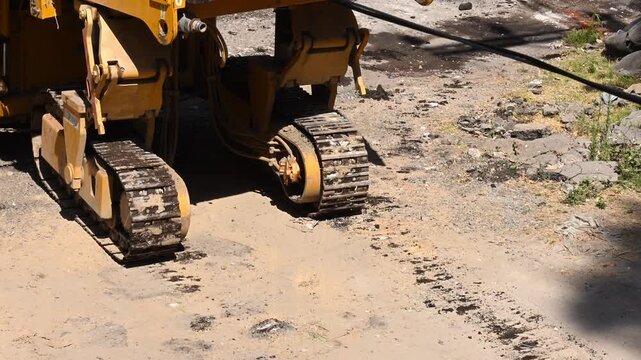 Detail of heavy machinery tracks on ground under construction