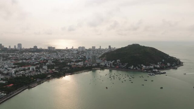 Aerial drone view of fishing boats and coastal town in Vung Tau Vietnam tropical seaside cityscape