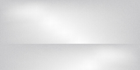 Obraz premium A minimalist white and grey wall interior background with soft window shadows. Ideal for studio backdrops, product presentations, and text insertions, creating a clean and modern aesthetic.