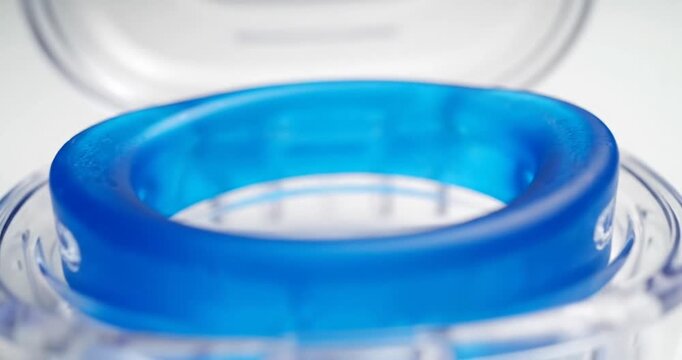 Clear case with a blue ring inside, showcasing its design and functionality for storage