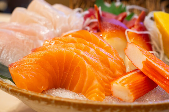 Assorted mixed sashimi set on ice with salmon, hokkigai clam, hamachi, and tamagoyaki, Japanese food platter