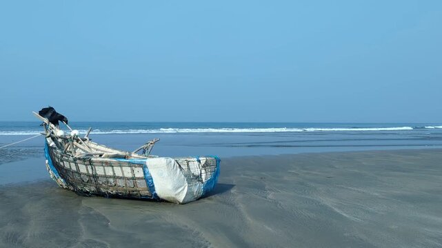 Serene Coastal View of a Rustic Wooden Boat on a Clear Day at the Seaside at cox's bazar