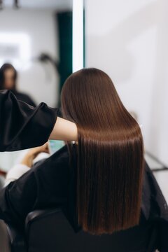 Woman getting professional shiny hair care treatment