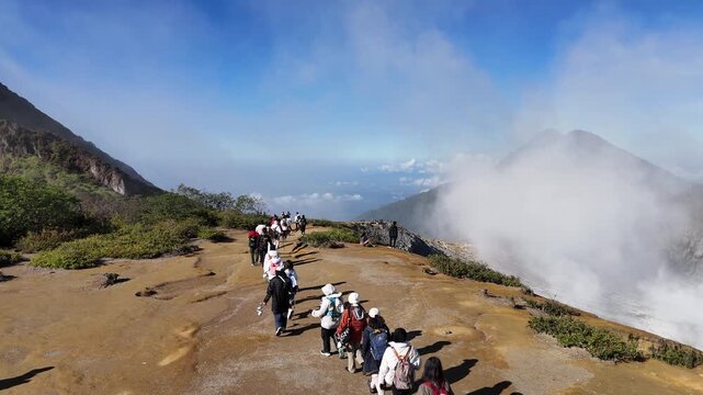 Hikers Trekking to Mount Ijen Crater at Sunrise, Famous Volcano Landscape in East Java Indonesia
