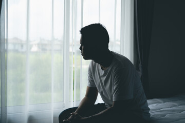 Solitary Reflection of a Young Man Contemplating Life While Seated by a Bright Window Surrounded by Soft Drapes in a Modern Interior Space