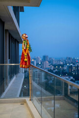 Fototapeta premium Traditional Gudi Padwa setup on modern apartment balcony with city view