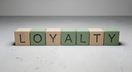 Wooden blocks spelling loyalty on modern gray background