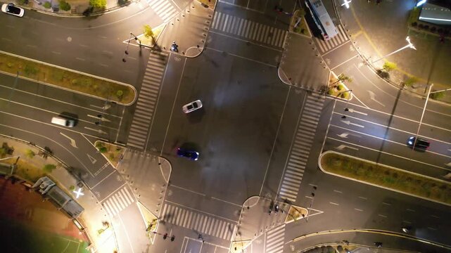 Aerial City Intersection at Night with Traffic and Crosswalks