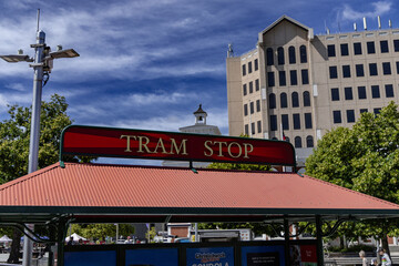 Obraz premium Tram Stop Urban Shelter Beside Office Building
