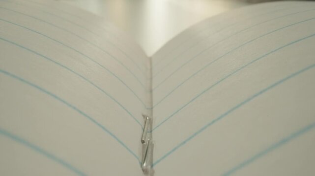 Closeup Lined Notebook Spine Converging, Soft Light, Stitched Binding, Blue Ruled Lines, Subtle Paper Grain, Calm Minimalist Mood, Student Study Scene, Archivist Inspection, Writer Pause