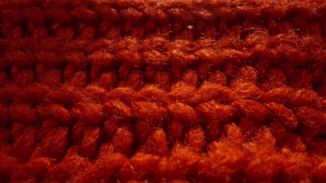 Closeup Of Cozy Knitted Fabric. Intimate Shot Highlighting Chunky Wool Textures With Deep Shadows And Fuzz. Macro Image Capturing Tactile Wool Knit With Fuzzy Details And Autumnal Warm Tones
