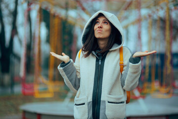Woman in White Teddy Jacket Shrugging Outdoors. Clueless girl in fuzzy sherpa fleece jacket outdoors  © nicoletaionescu