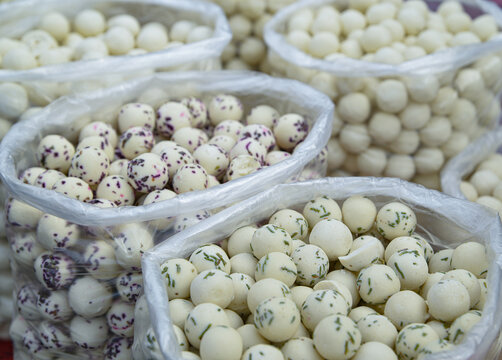 White and colored milk balls in bags are the national Uzbek dairy dish kurt. curd mass dried to the state of stone, mixed with spices and herbs, rolled into a ball
