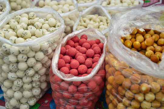 White and colored milk balls in bags are the national Uzbek dairy dish kurt. curd mass dried to the state of stone, mixed with spices and herbs, rolled into a ball