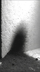 cracked abstract monochrome surface with intricate branching fissures illuminated by dramatic spotlight and floating particles