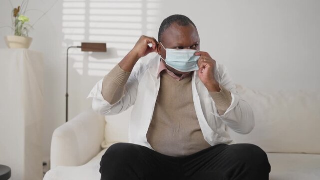 Health professional putting protective medical mask on face, dangerous virus. Pandemic of unknown respiratory infection and seasonal epidemics of influenza, protection for physician, how use face mask