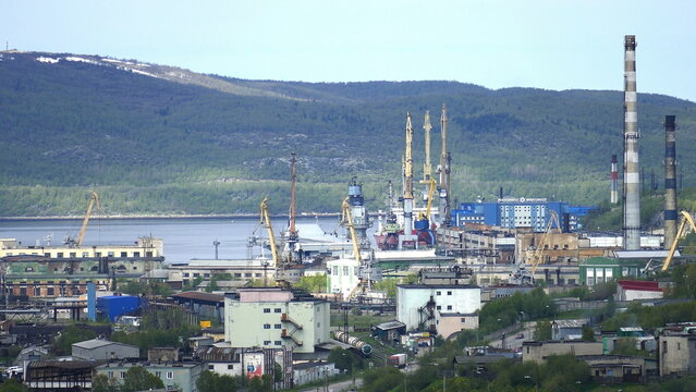 Murmansk, Russia - June 7, 2020: The aircraft-carrying cruiser Admiral Kuznetsov at the pier at the repair base of the 35th Shipyard. View from the Zeleny Mys Hill.