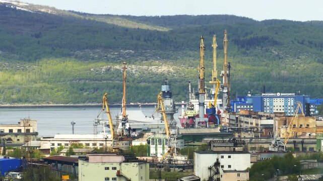 Murmansk, Russia - June 7, 2020: The aircraft-carrying cruiser Admiral Kuznetsov at the pier at the repair base of the 35th Shipyard. View from the Zeleny Mys Hill.