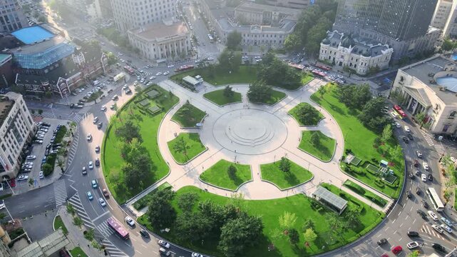Aerial View of Circular City Plaza with Green Spaces and Traffic