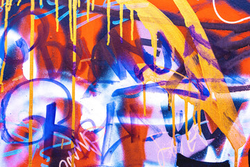 Abstract graffiti street art with bright orange, blue, yellow spray paint drips. 2000s urban style, neon colors, layered spray paint, vibrant composition. Posters, flyers, digital art, creative banner © Aleksandra Konoplya