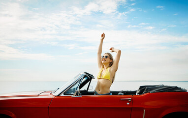 Beach, freedom and woman in car, road trip and laughing with sunglasses, tourism and summer holiday. Outdoor, traveler and person with smile in vehicle, space and happiness on vacation in nature