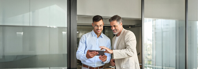 Business team of two happy successful professional business men executive working together standing...