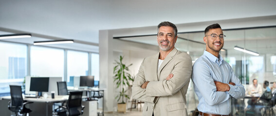 Two smiling confident business men leaders, happy corporate managers, young and middle aged...