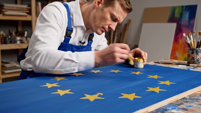 Man painting European flag in studio
