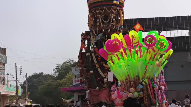 Maski, Karnataka, India - February 2, 2026: Decorated religious chariot procession moving through street with large crowd during local festival celebration.