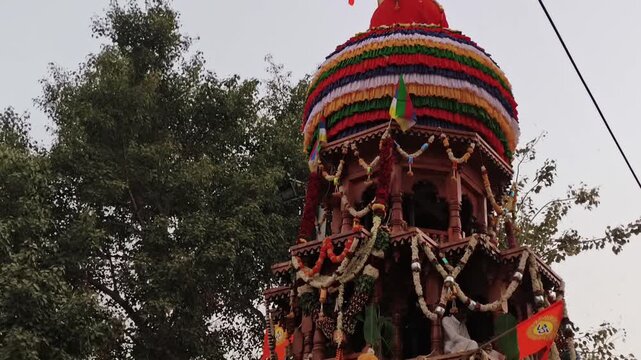 Maski, Karnataka, India - February 1, 2026: Flower petals falling from sky over decorated temple chariot during vibrant Hindu religious celebration.