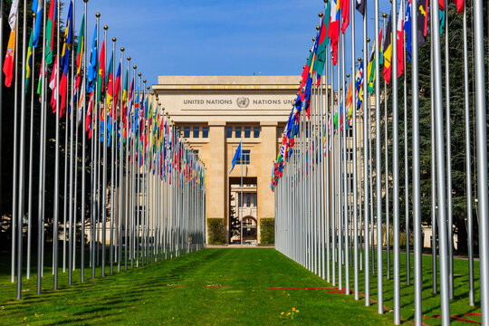 Rows of the United Nations member states flags in a front of Palace of United Nations in Geneva, Switzerland