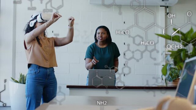 Headset activating, VR user wearing blouse demonstrating molecule overlay at lab, laptop tracking