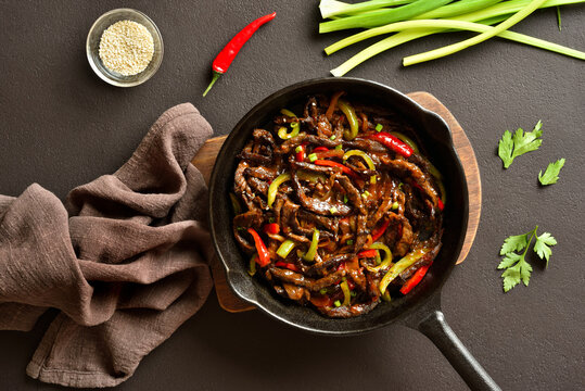 Chinese style skillet of fried thinly sliced into strips beef and peppers