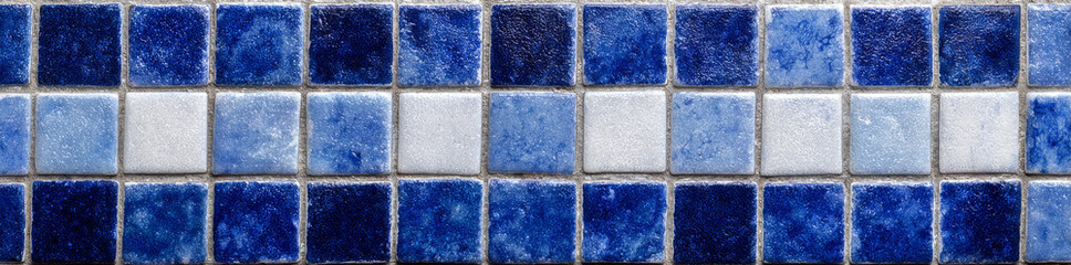 Fototapeta premium Blue and white ceramic mosaic tiles with border seamless pattern create vibrant and textured surface perfect for decorative wall or floor design