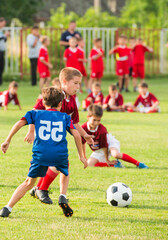 Obraz premium Boys kicking football on the sports field
