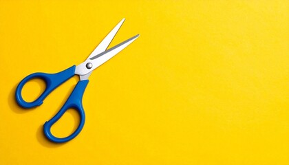 A pair of blue‑handled scissors rests diagonally on a vivid yellow background, symbolizing creativity, design, and striking visual contrast in minimalist composition.