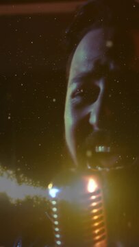 Vertical video: Singer singing into mic while drum beat sparking gold dust, creating music focus